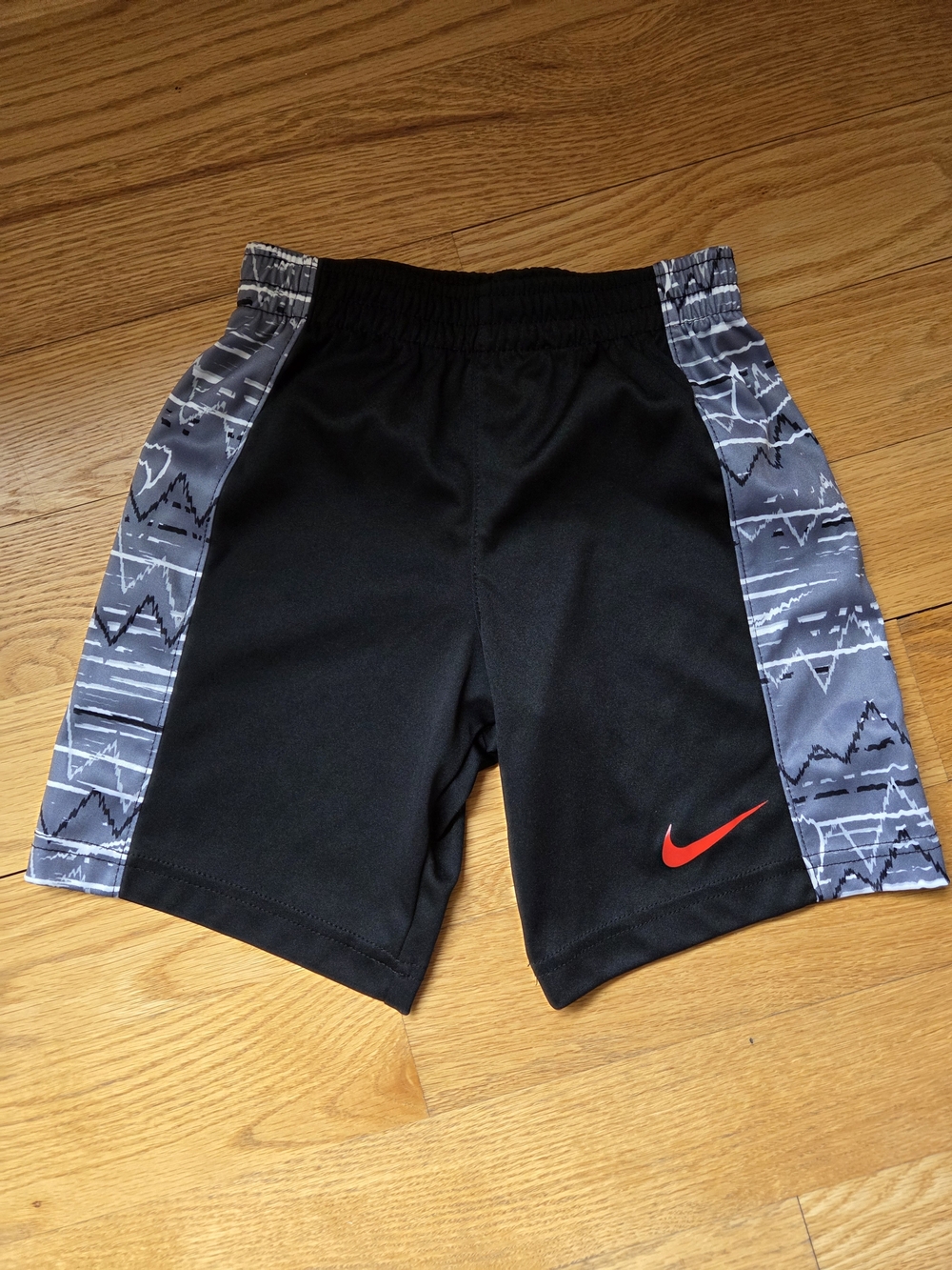 Nike Black Kids Athletic Shorts with Gray Pattern Panels and Red Swoosh